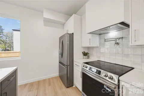 a kitchen with a stove and a refrigerator