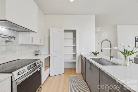 a kitchen with a sink stove and cabinets