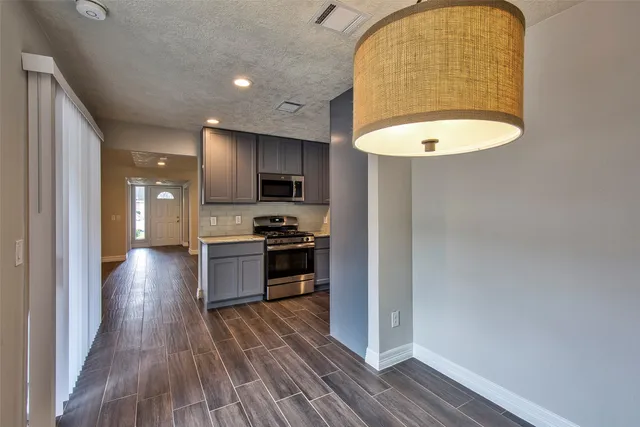 a kitchen with a wooden floor and a sink
