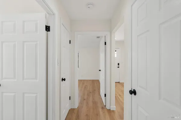 a view of room with window and wooden floor