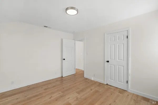 a view of room with walk in closet and cabinet