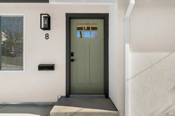a view of a hallway with wooden floor and entryway