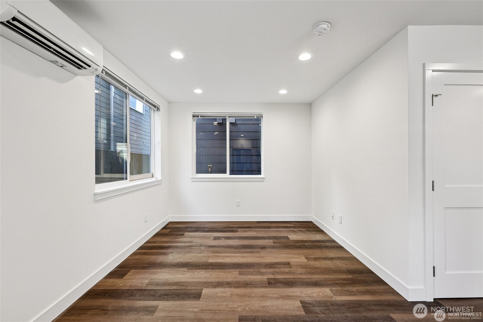 5259 Brooklyn Avenue Northeast Seattle, WA 98105 - Photo 5 of 40 a view of an empty room with wooden floor and a window