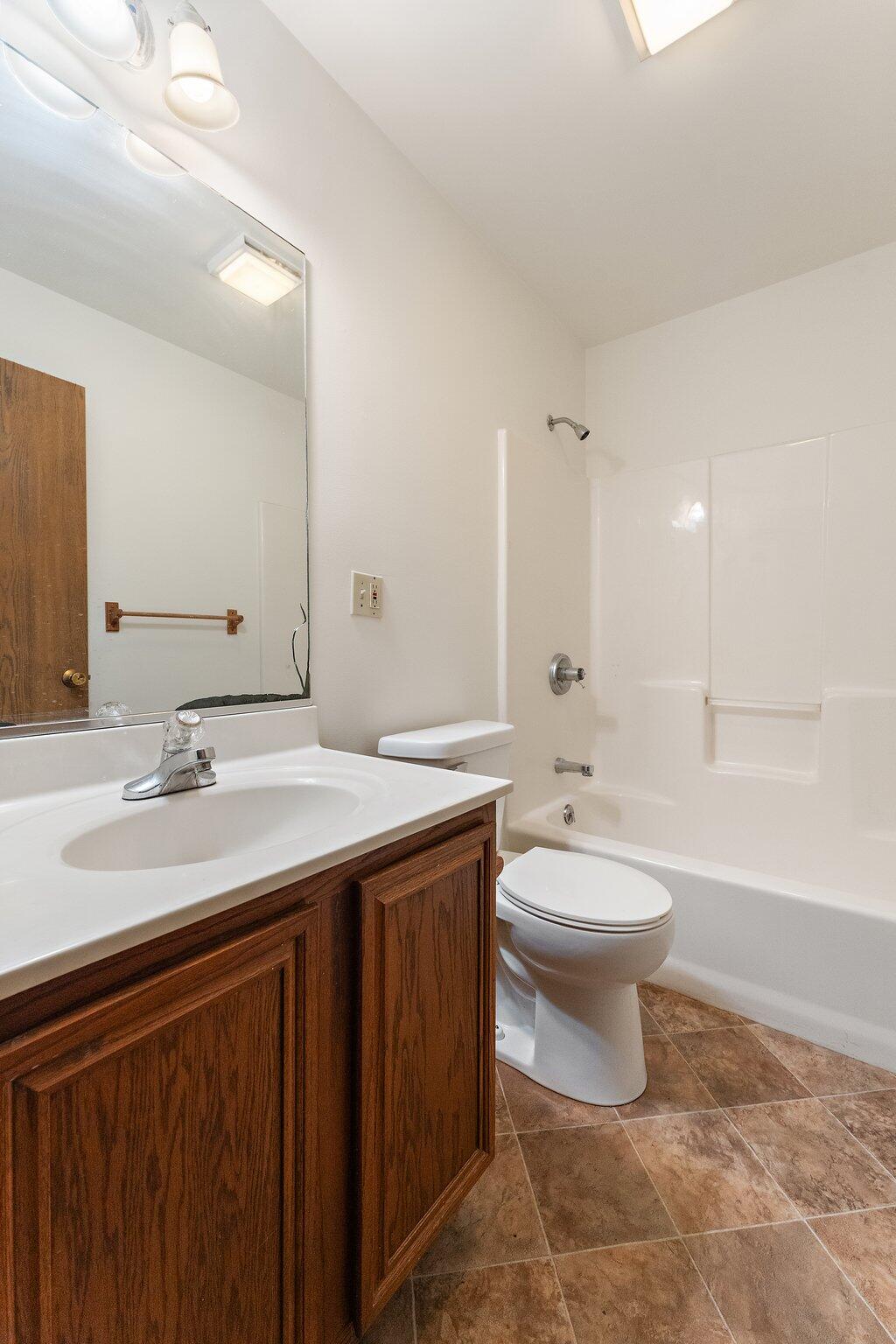 402 Alice Street Kouts, IN 46347 - Photo 11 of 21 a bathroom with a double vanity sink toilet and a bathtub