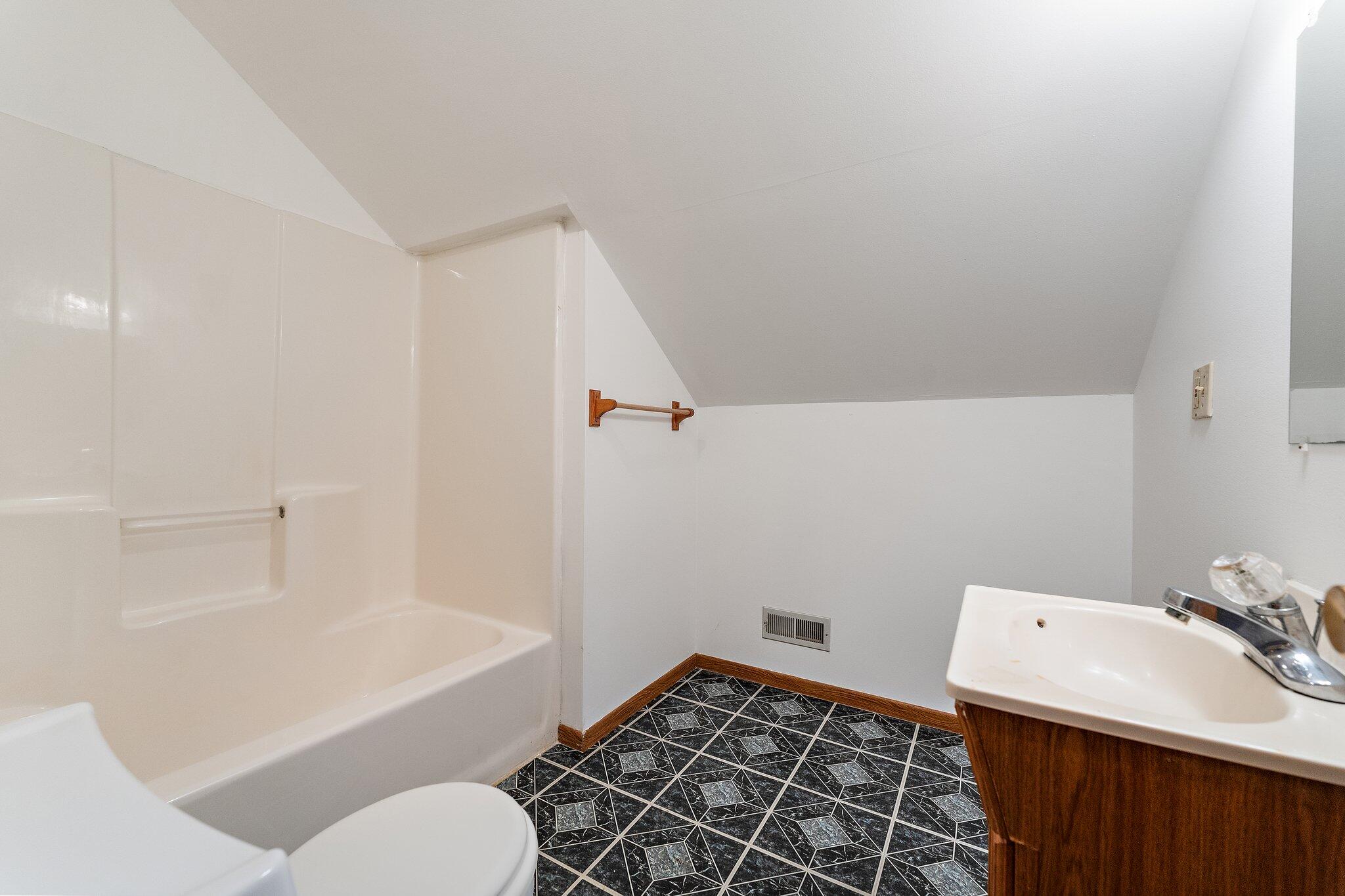 402 Alice Street Kouts, IN 46347 - Photo 14 of 21 a bathroom with a sink toilet and shower