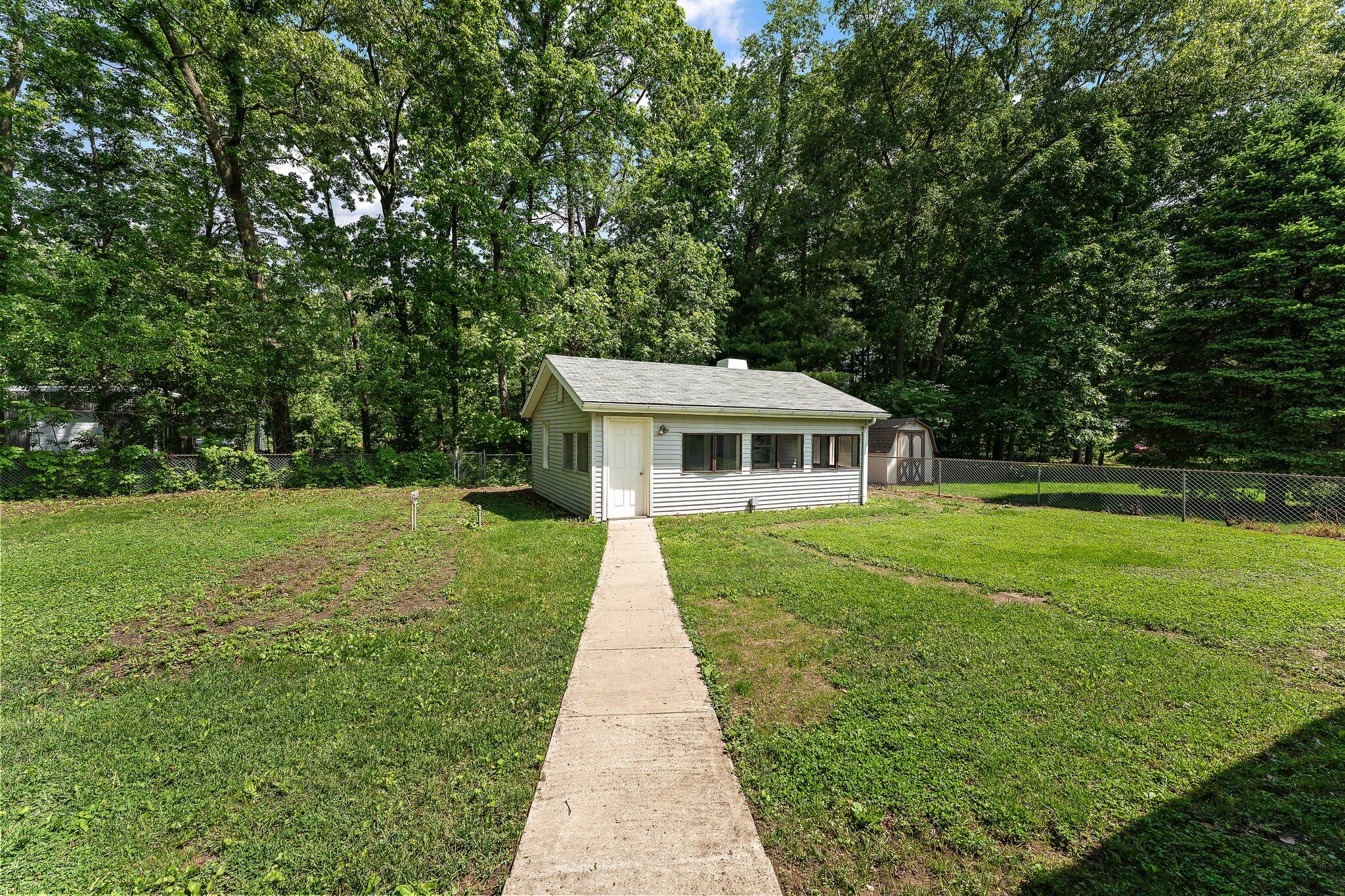 402 Alice Street Kouts, IN 46347 - Photo 17 of 21 a front view of a house with garden
