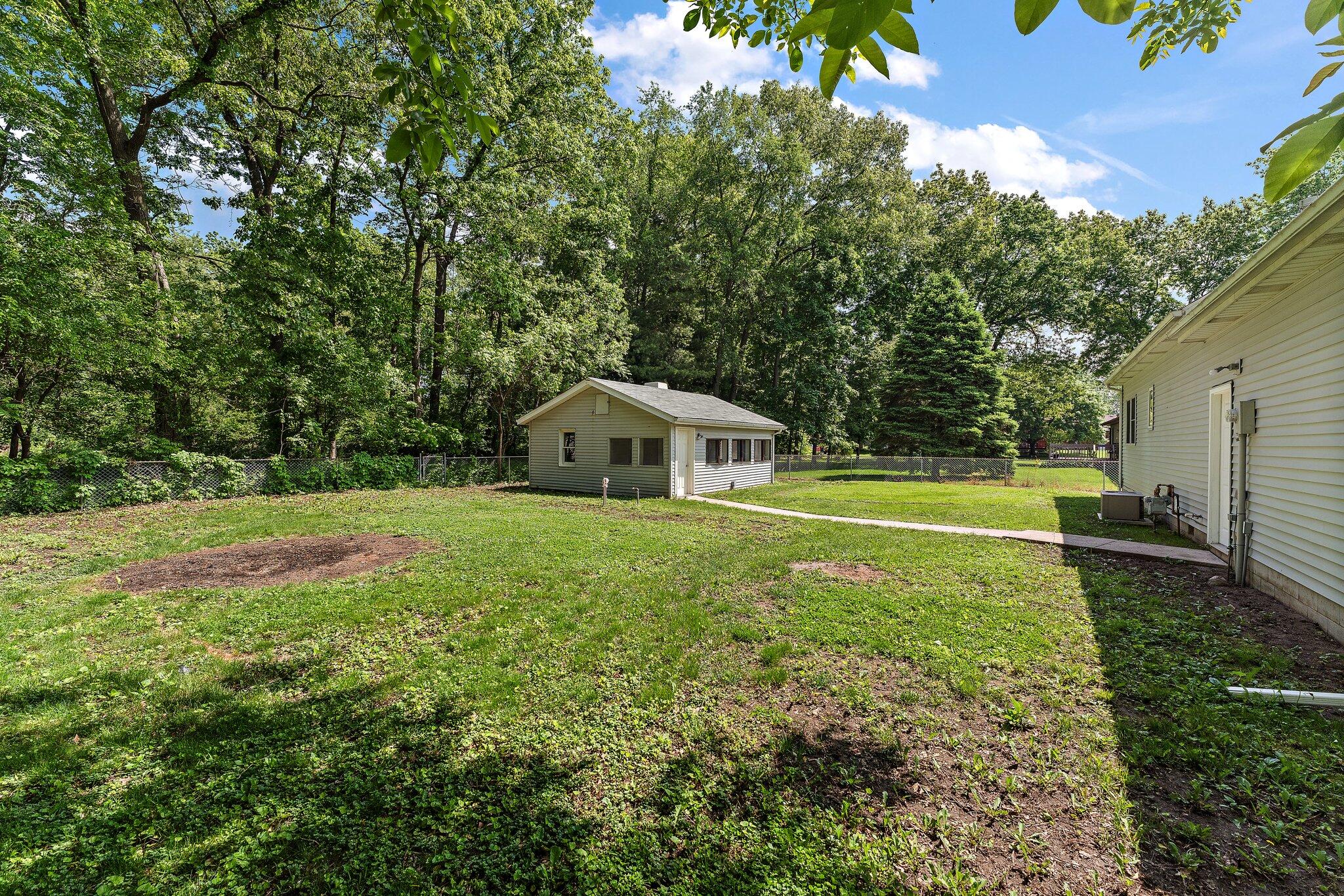 402 Alice Street Kouts, IN 46347 - Photo 18 of 21 a view of a house with a yard