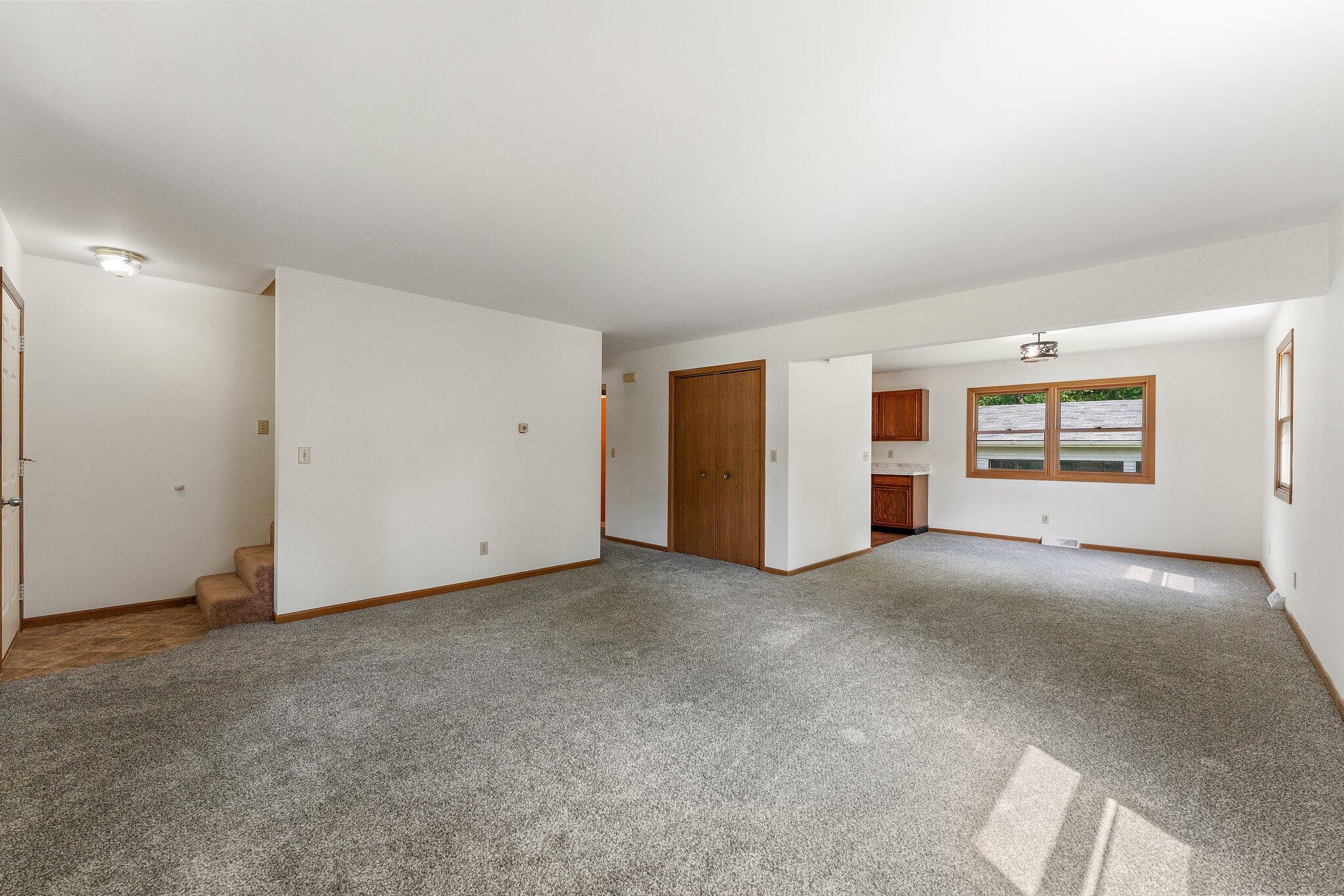 402 Alice Street Kouts, IN 46347 - Photo 6 of 21 an empty room with a empty space and windows