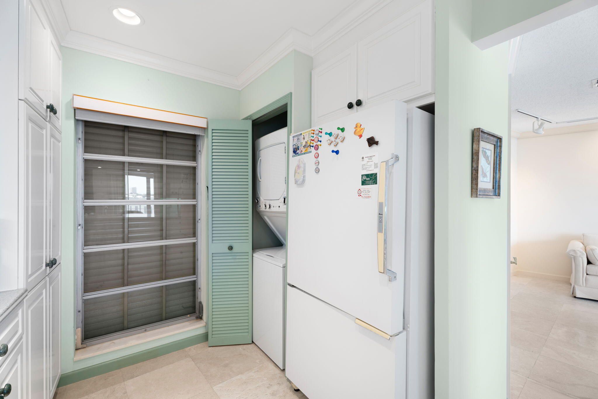 371 Wilma Circle, Unit 5 Riviera Beach, FL 33404 - Photo 11 of 43 a white refrigerator freezer and a refrigerator in a room
