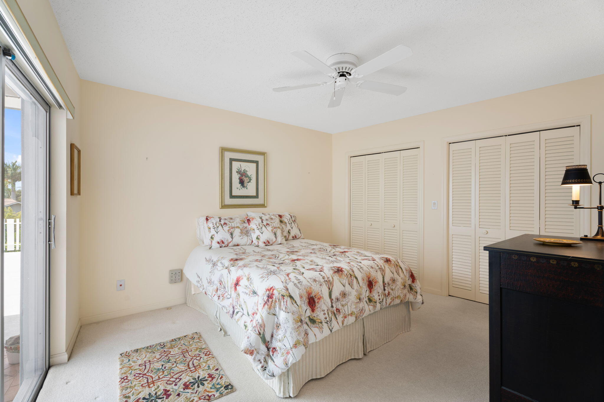 371 Wilma Circle, Unit 5 Riviera Beach, FL 33404 - Photo 13 of 43 a bedroom with a bed and a table