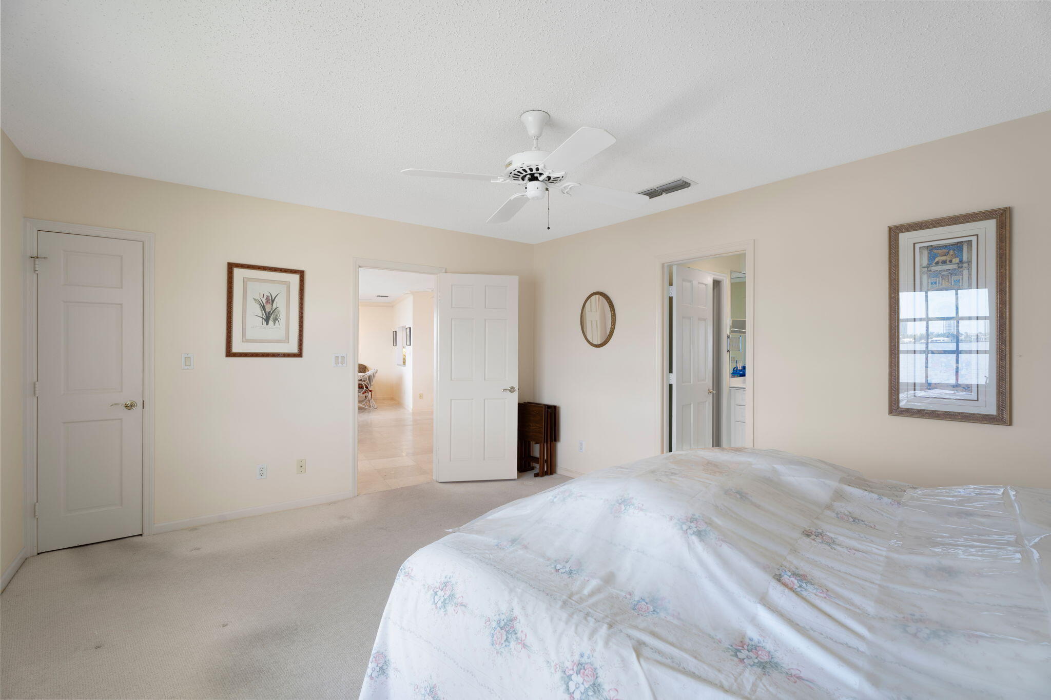 371 Wilma Circle, Unit 5 Riviera Beach, FL 33404 - Photo 18 of 43 a bedroom with a large bed and a chandelier