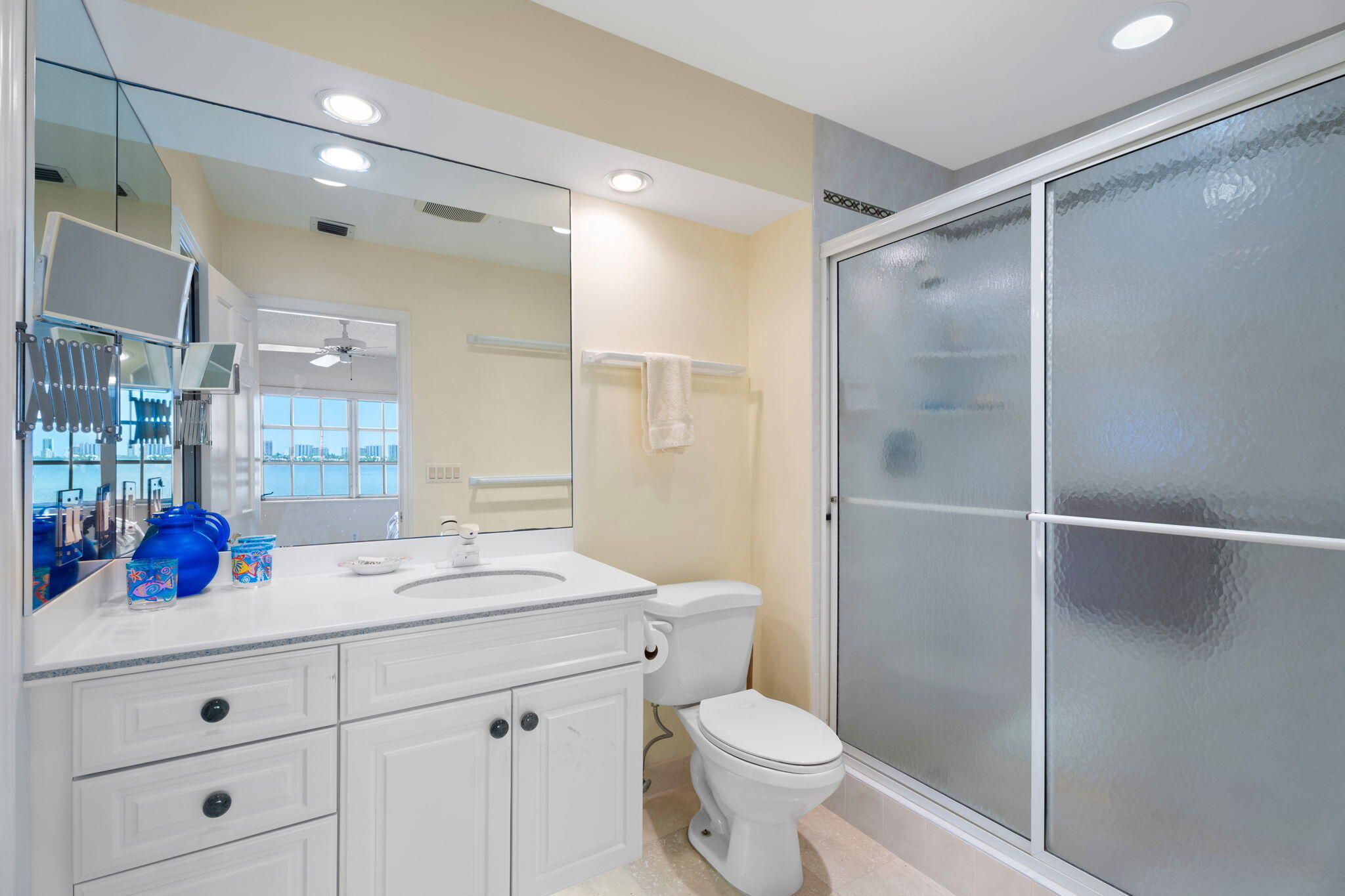 371 Wilma Circle, Unit 5 Riviera Beach, FL 33404 - Photo 19 of 43 a bathroom with a sink a toilet a large mirror and shower