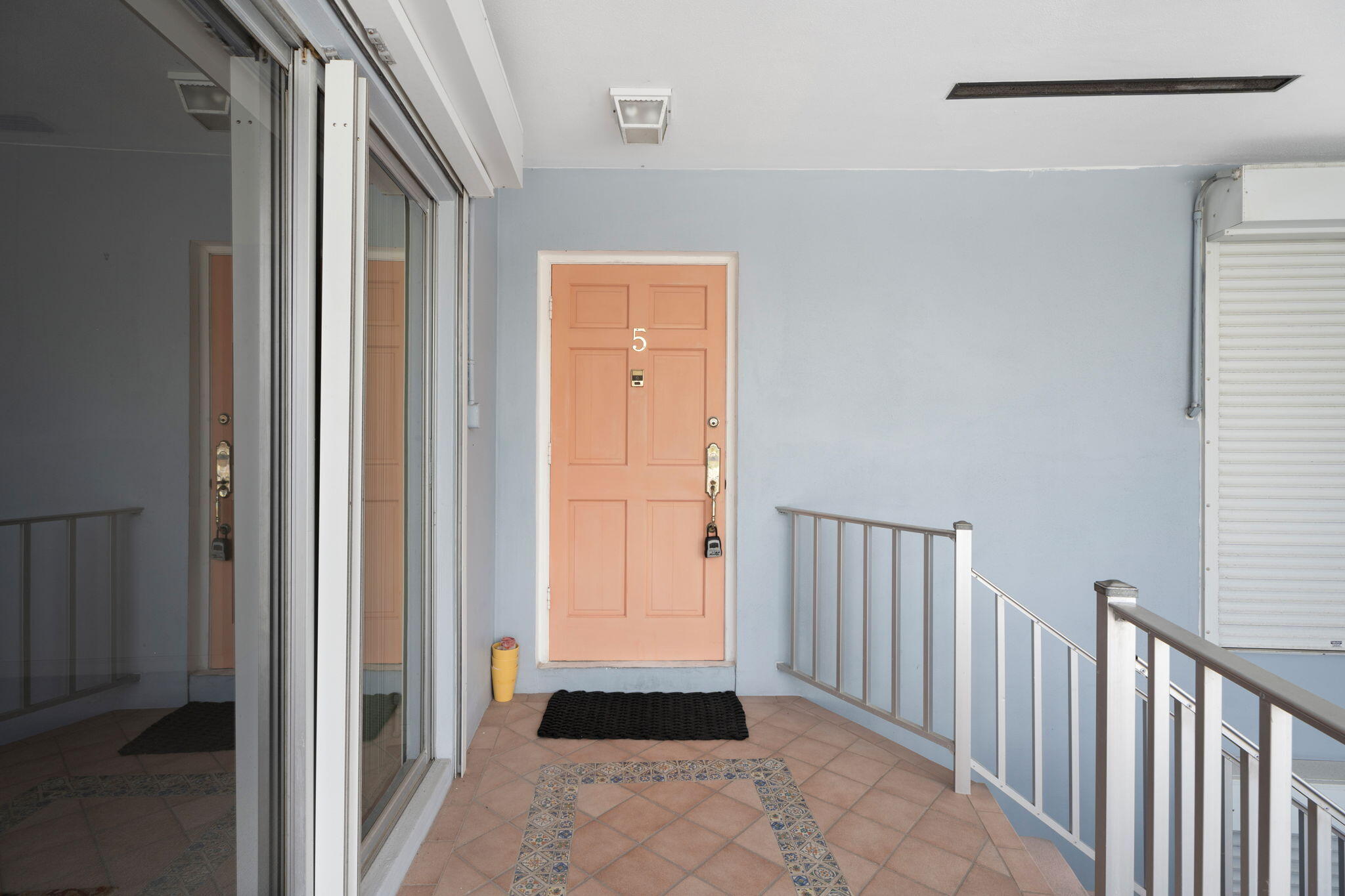 371 Wilma Circle, Unit 5 Riviera Beach, FL 33404 - Photo 21 of 43 a hallway with sliding door and front door