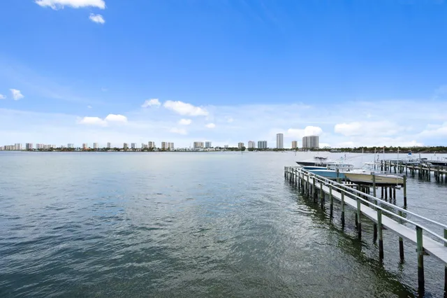 a view of house with large windows and a small yard
