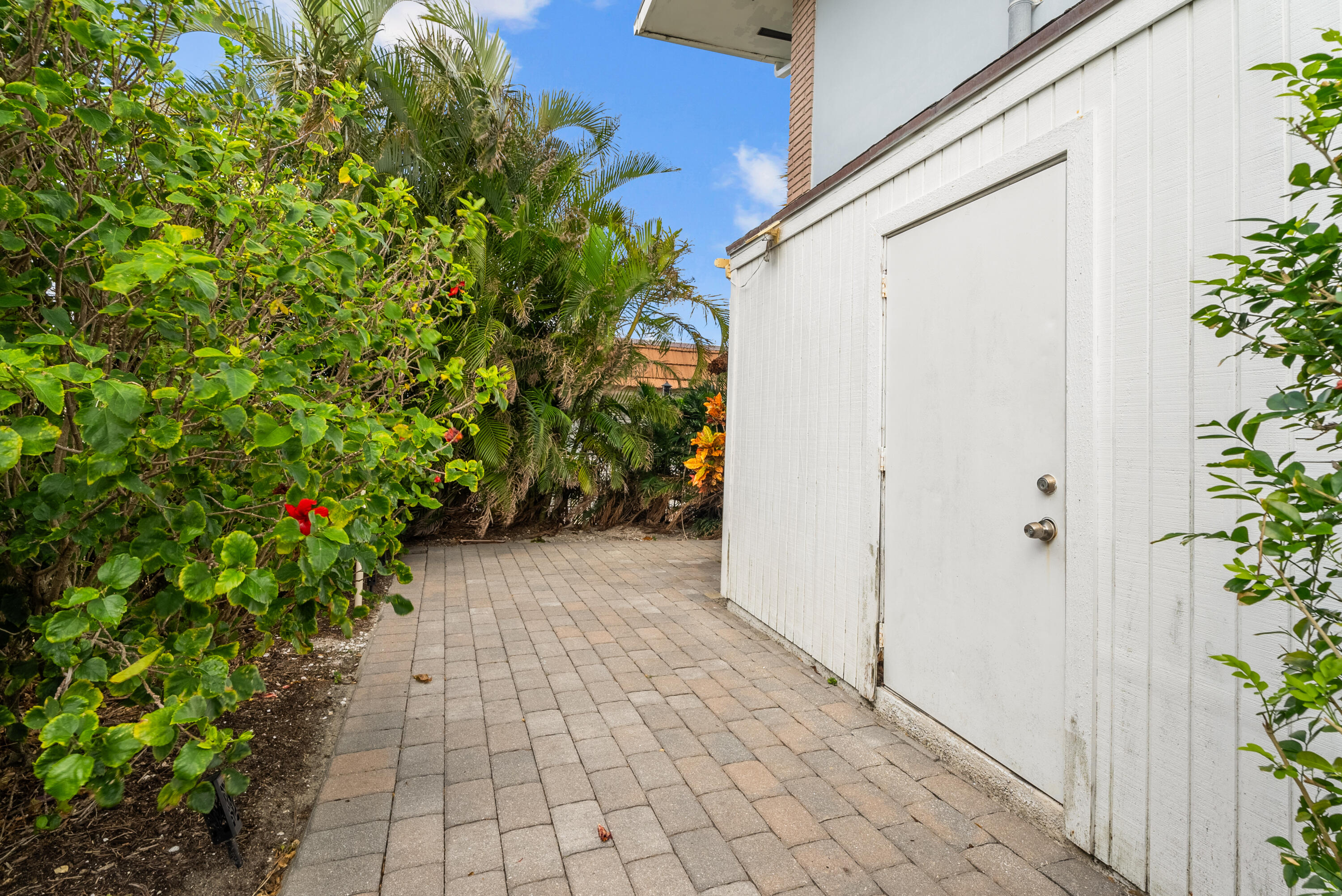 371 Wilma Circle, Unit 5 Riviera Beach, FL 33404 - Photo 34 of 43 a view of a pathway with a yard