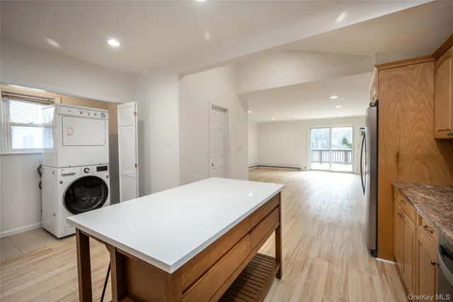 a view of a kitchen with wooden floor and a sink