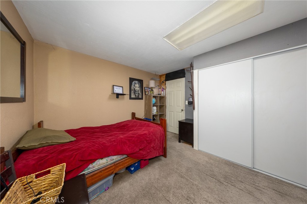 566 South Sage Avenue Rialto, CA 92376 - Photo 24 of 28 a bedroom with a bed and a closet