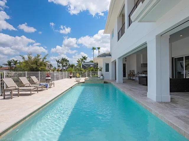 a view of a swimming pool with a lounge chair