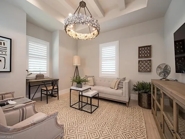a living room with furniture and a chandelier