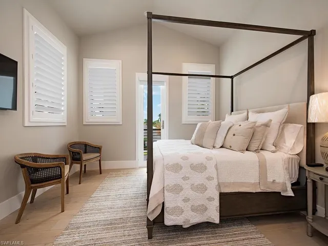 a bedroom with furniture and a window