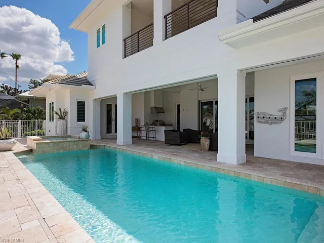 a swimming pool view with a outdoor seating
