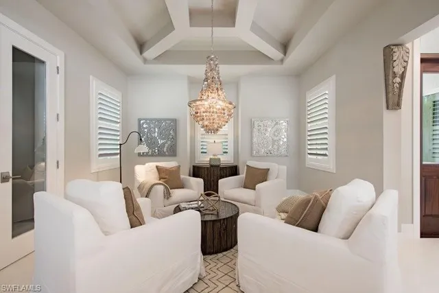 a living room with furniture and a chandelier