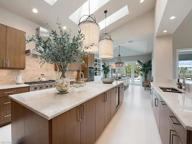 a kitchen with sink stove and cabinets