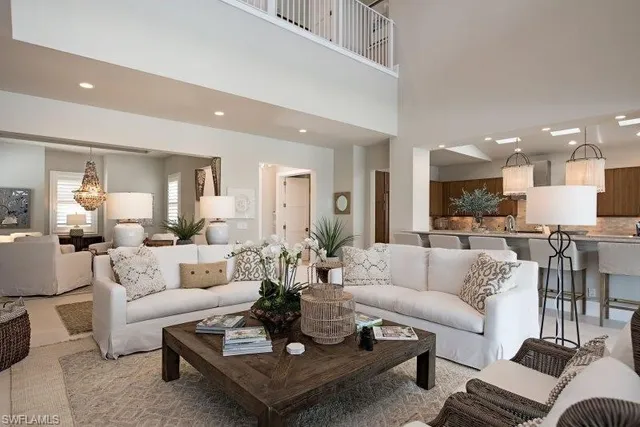 a living room with furniture kitchen view and a table