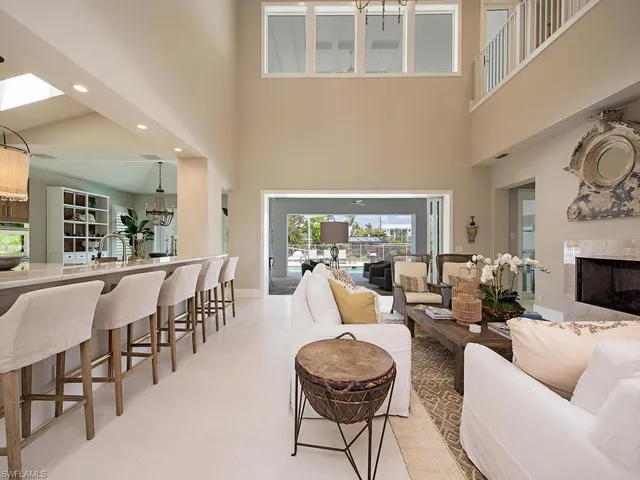a living room with fireplace furniture and a large window
