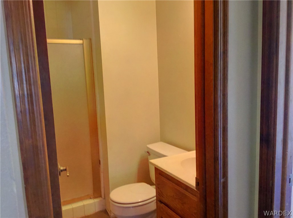 1190 Ramar Road Bullhead City, AZ 86442 - Photo 17 of 32 a bathroom with a granite countertop toilet and a sink