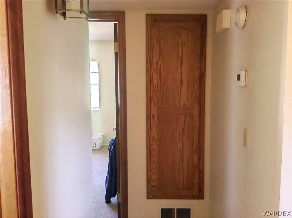 1190 Ramar Road Bullhead City, AZ 86442 - Photo 22 of 32 a view of a hallway with wooden floor