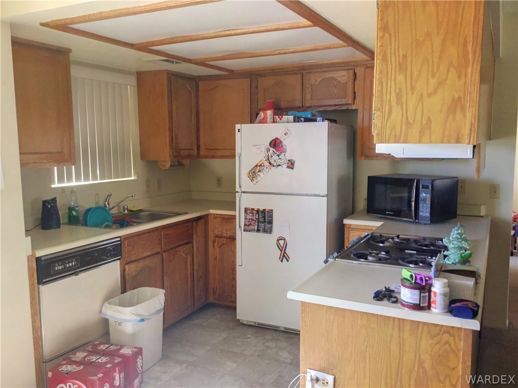 1190 Ramar Road Bullhead City, AZ 86442 - Photo 3 of 32 a kitchen with a refrigerator and a stove