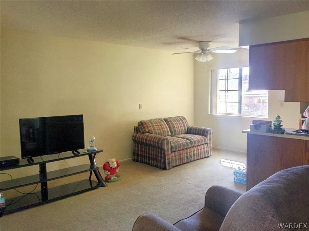 1190 Ramar Road Bullhead City, AZ 86442 - Photo 9 of 32 a living room with furniture and a flat screen tv