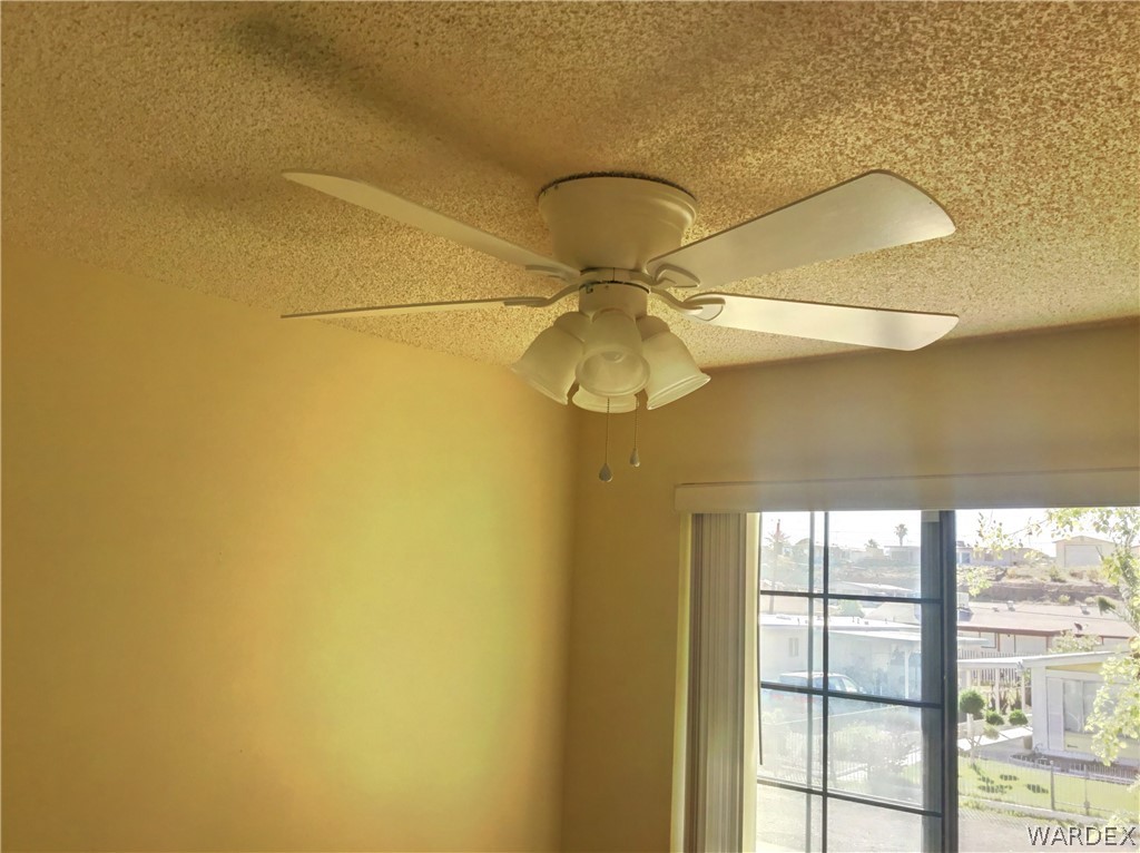1190 Ramar Road Bullhead City, AZ 86442 - Photo 10 of 32 a fan in a bathroom next to a window