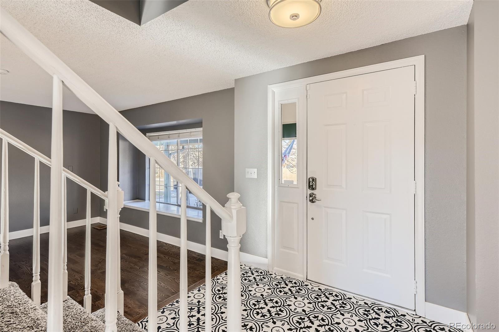 642 Northridge Road Highlands Ranch, CO 80126 - Photo 14 of 31 a view of staircase with white walls and door