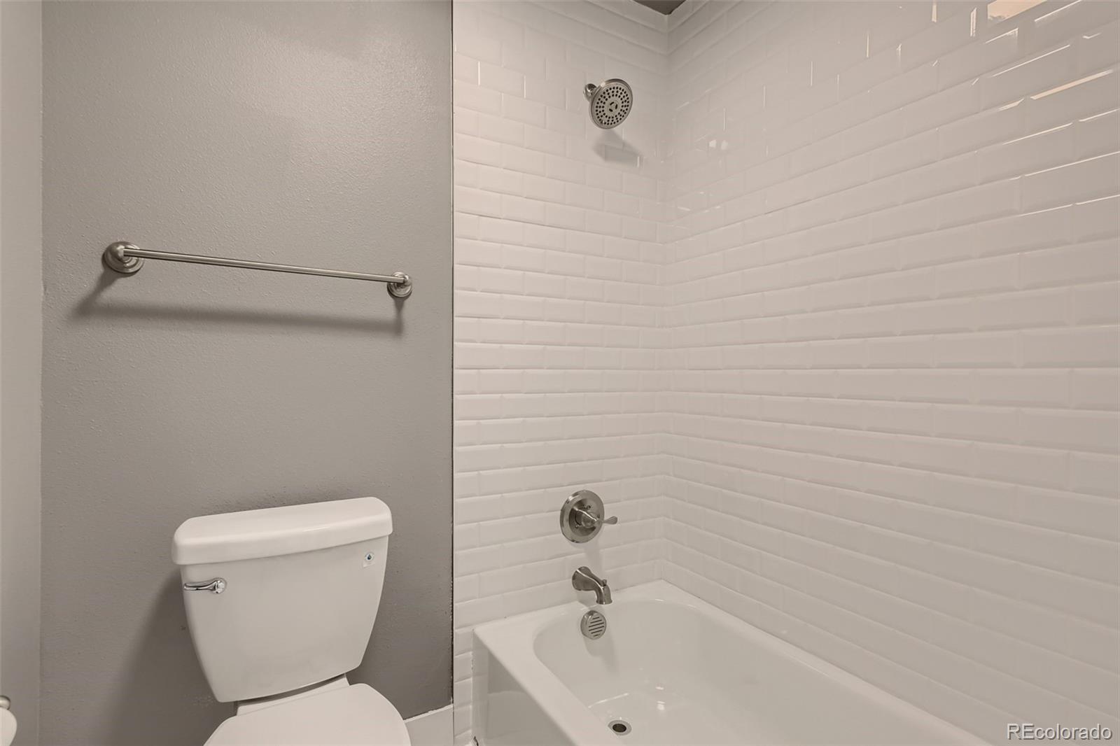 642 Northridge Road Highlands Ranch, CO 80126 - Photo 18 of 31 a white toilet sitting next to a bath tub