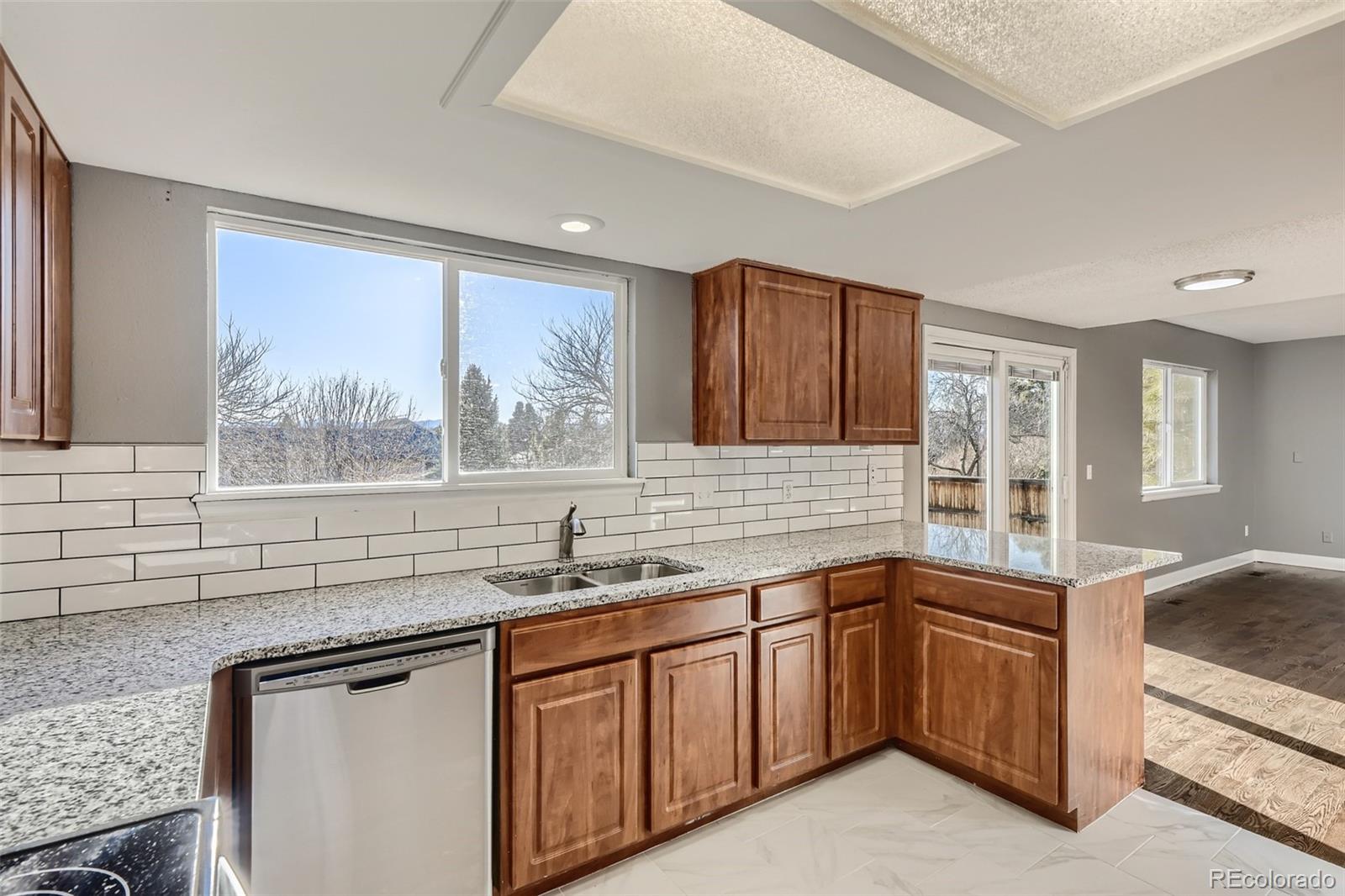 642 Northridge Road Highlands Ranch, CO 80126 - Photo 5 of 31 a kitchen with a sink stove and cabinets