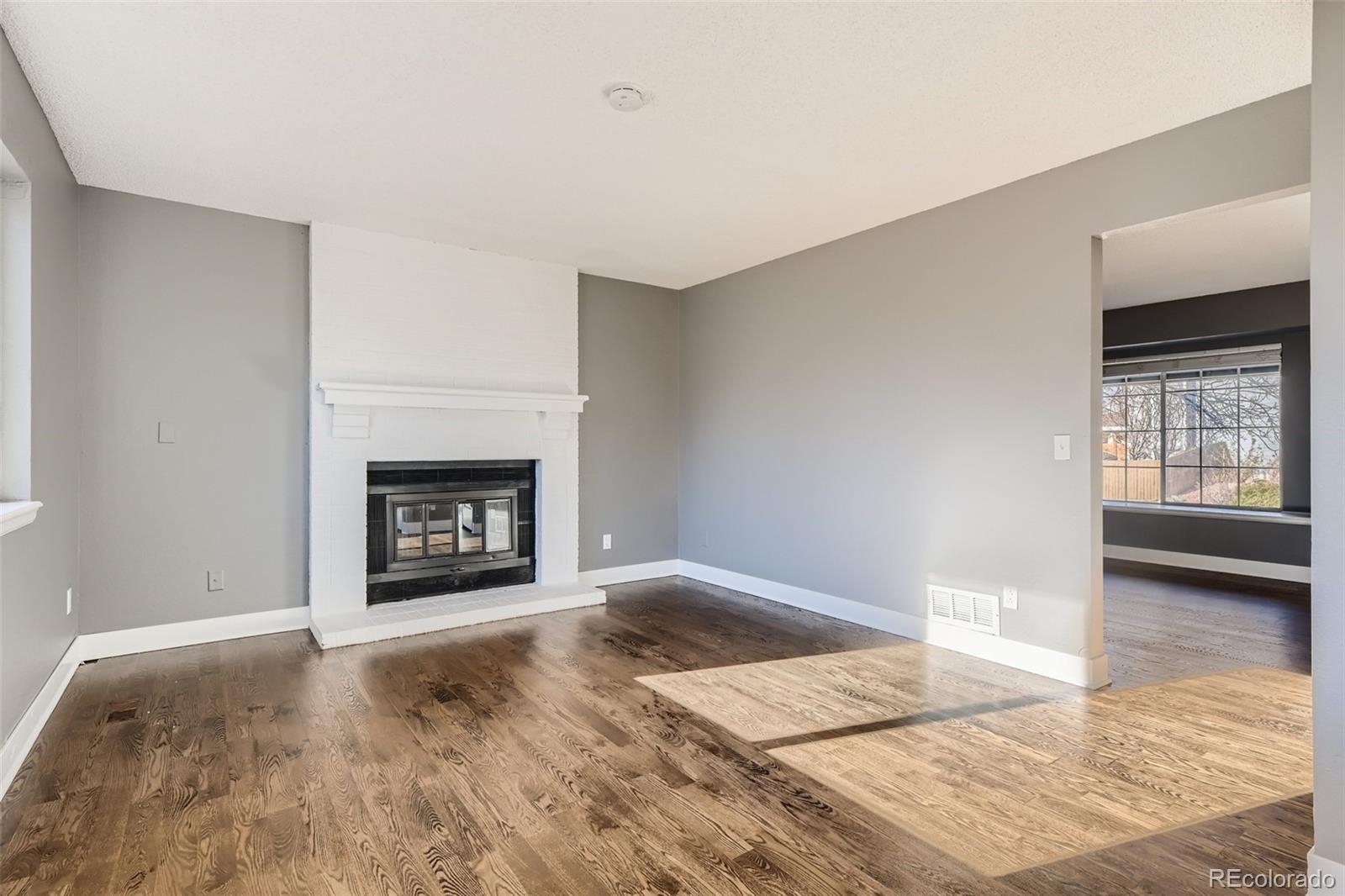 642 Northridge Road Highlands Ranch, CO 80126 - Photo 10 of 31 a view of an empty room with window and fire place