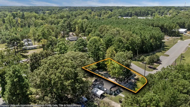 an aerial view of a residential house with a yard