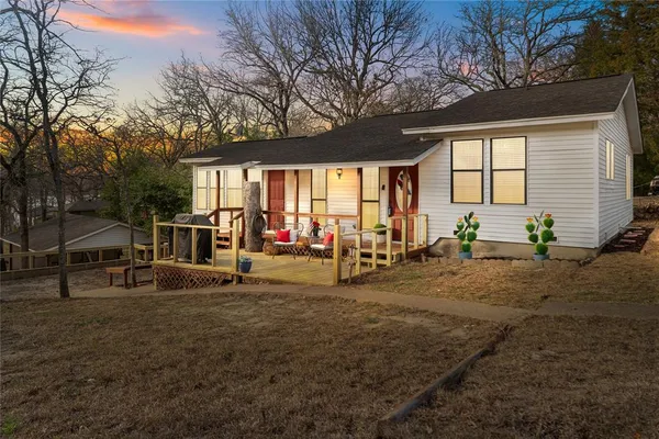 a view of a house with backyard and sitting area