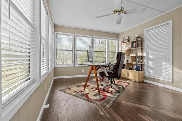 a view of a livingroom with furniture and a floor to ceiling window
