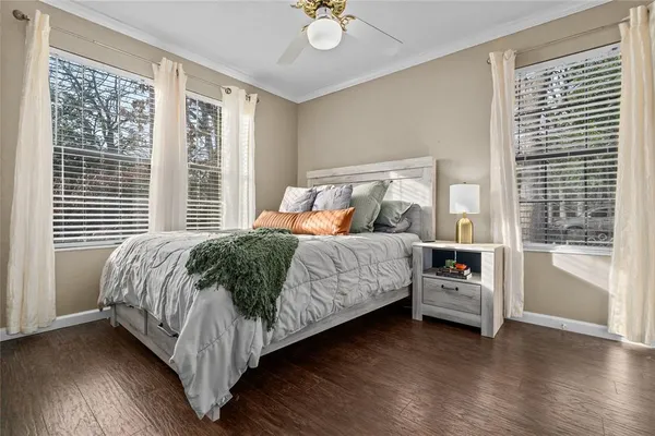a bedroom with a bed and a large window with outer view
