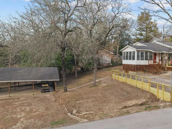an aerial view of a house with yard and sitting area