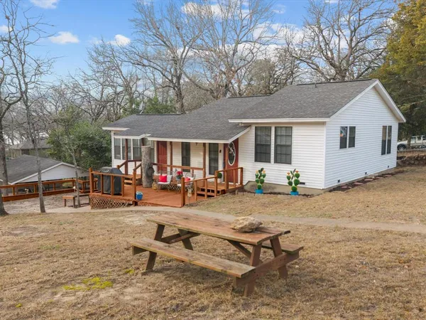 a view of a house with backyard porch and sitting area
