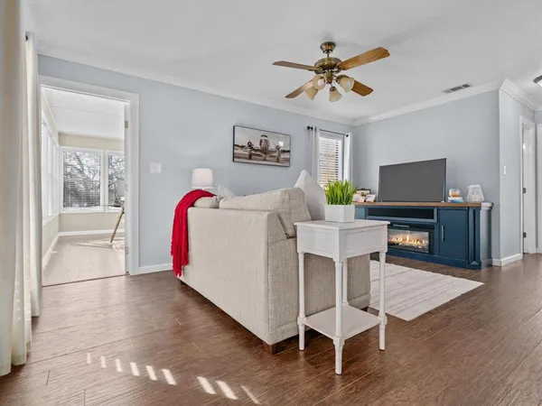 a living room with furniture and a wooden floor
