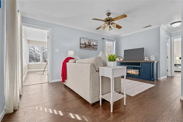 a living room with furniture and a wooden floor