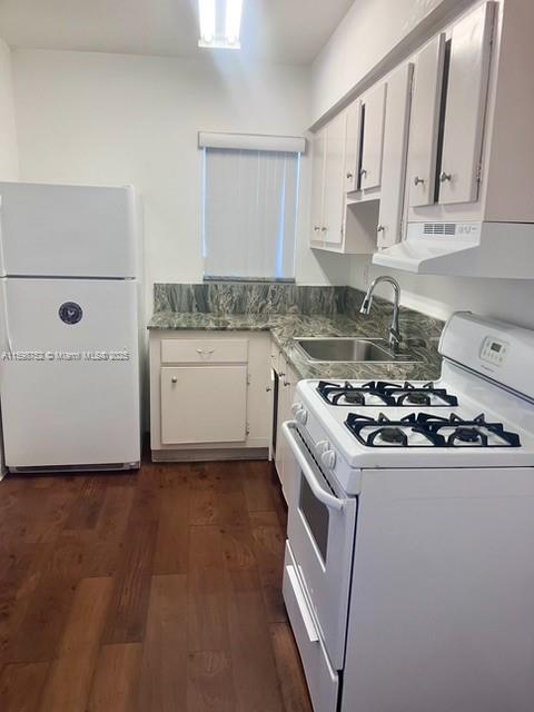 4250 Southwest 67th Avenue, Unit 49 Miami, FL 33155 - Photo 5 of 11 a white kitchen with a sink and a stove