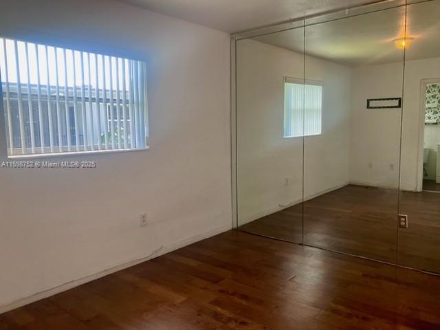 4250 Southwest 67th Avenue, Unit 49 Miami, FL 33155 - Photo 7 of 11 an empty room with wooden floor and windows