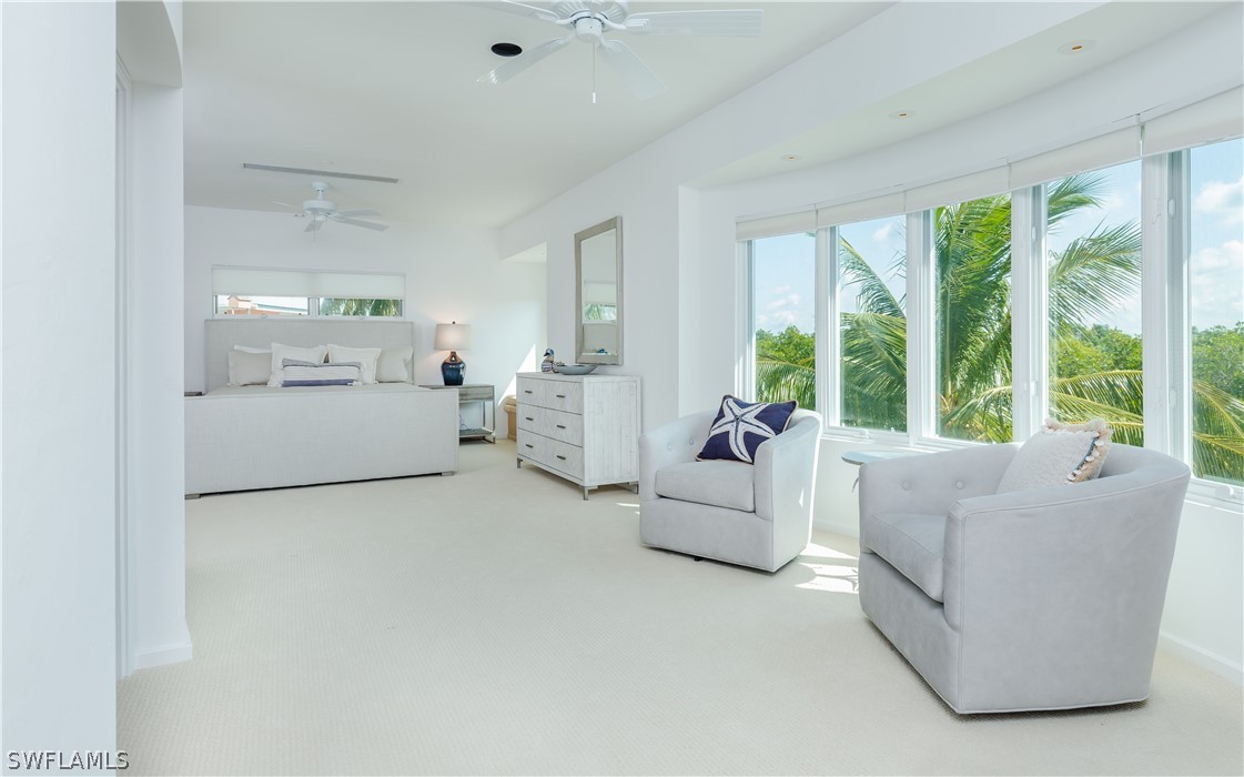 591 Rum Road Captiva, FL 33924 - Photo 12 of 34 a living room with furniture and large windows