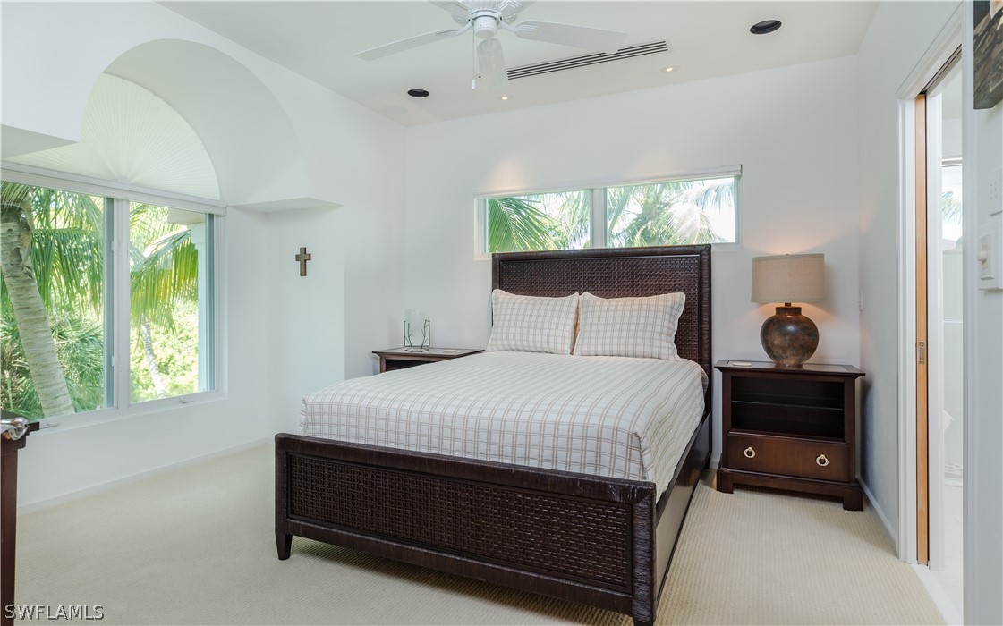 591 Rum Road Captiva, FL 33924 - Photo 15 of 34 a bedroom with a bed and window